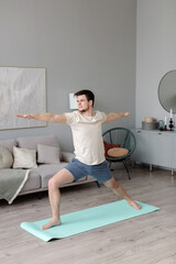 A young man practices yoga in the studio. yoga class. High quality photo