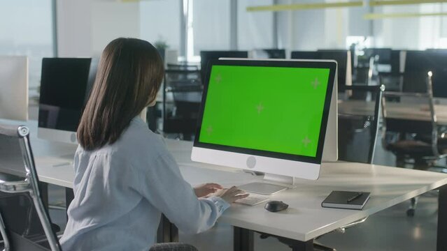 Business Woman Hands Working Internet on Computer On Desk. Girl Typing Keyboard on PC with Green Screen Notebook. Close Up Female Freelancer Searches For Information on The Internet