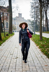 romantic girl in vintage hat in autumn park with bag