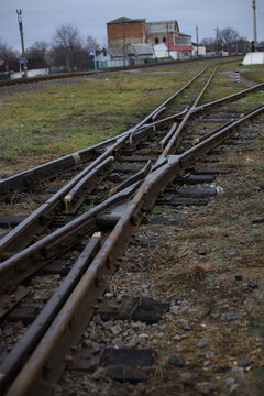 turnout railroad tracks of the old model near grass and earth. for introductory instructions books and booklets