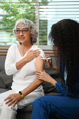 Practitioner nurse injecting insulin into diabetic senior female upper arm. Diabetes, health care and people concept