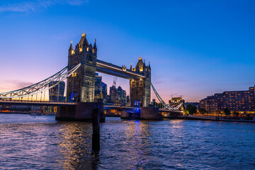View of the famous Tower Bridge and skyline of London, UK, during beautiful sunset time in summer