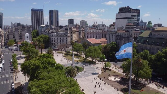 Aerial of Plaza de Mayo, Buenos Aires skyline and flag of Argentina