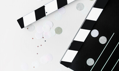 clapperboard, film strip and confetti for movie party. stylish layout with cinema paraphernalia on...