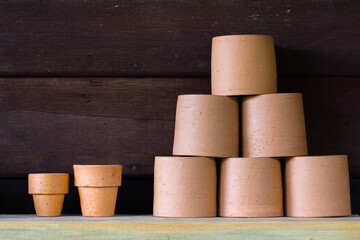 Vintage tone of Flower clay pots on wooden.