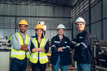 Portrait of automation engineer team standing and looking camera in industrial factory. 