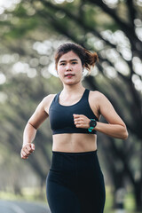 Fototapeta premium young asian woman jogging at park