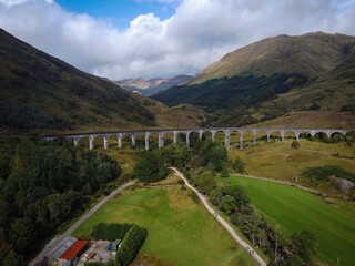 Scenic aerial view of Glenfinnan viaduct with train by autumn, Scotland