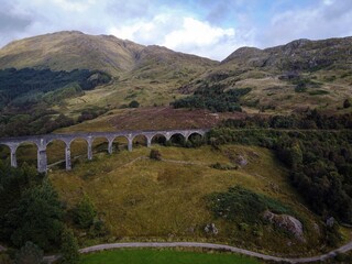 Scenic aerial view of Glenfinnan viaduct with train by autumn, Scotland