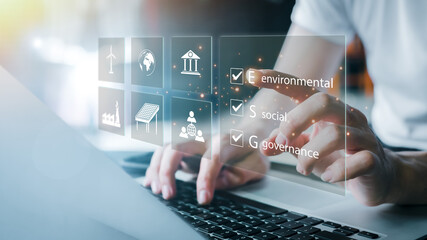 ESG. environment social governance investment business concept. Businessmen use a computer to...
