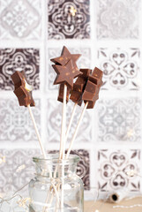 Homemade milk chocolate star shaped chocolate lolly on a stick.