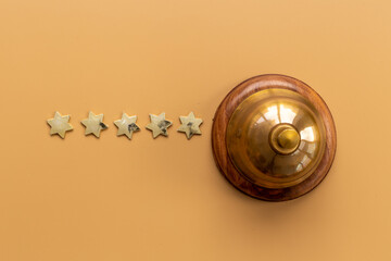 Vintage golden hotel service bell with five stars