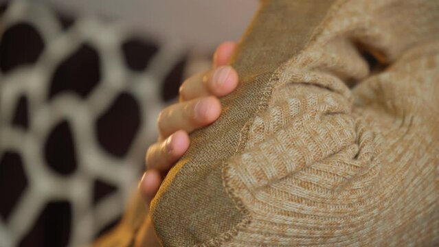 Patch on a man wool sweater. Concept needlework, recycling and thrift. Selective focus