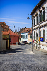 Fototapeta na wymiar Street view of sibiu old town with coble stone road and vintage lamp posts