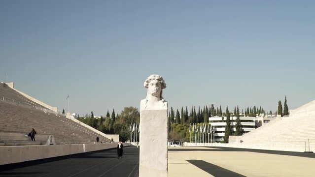 Revealing shot of the stone head statue of the herm inside Panathenaic Stadium