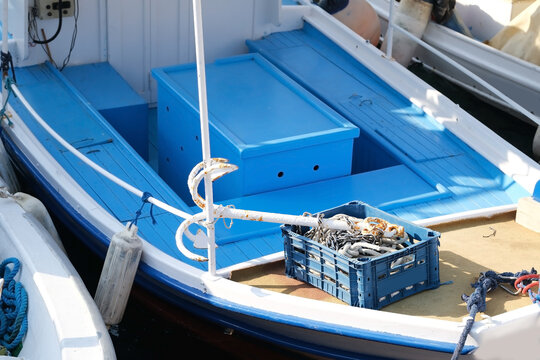 White Anchor And Fishing Net Lies In A Fishing Boat Deck