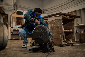 Afro american craftsman working as carpenter in a carpentry workshop, Small family business concept of young entrepreneurs.