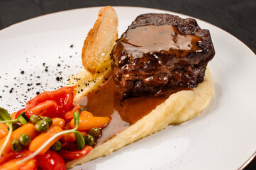 Fresh tasty steak with mashed potatoe and boiled vegetables on wooden background