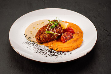 Dish of tasty cuttlet with puree and vegetables on wooden background