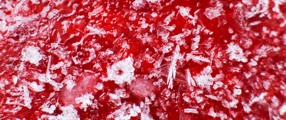 Mashed red fresh frozen strawberries background closeup. banner