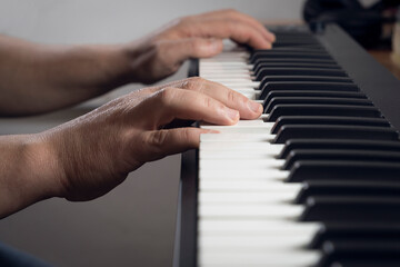 Fototapeta na wymiar Detail of a man playing a midi keyboard