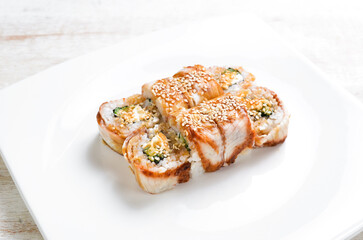 Traditional Japanese sushi rolls on a white plate. Top view. Asian food. On a white background.