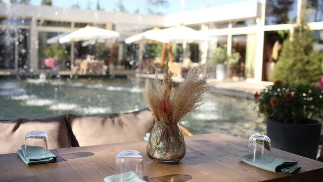 a table in a cafe restaurant near a fountain in summer