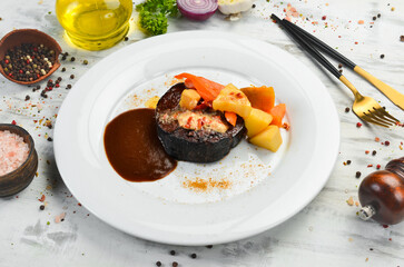 Veal steak baked with vegetables on a plate. Restaurant menu. European cuisine.
