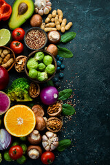 Organic food on a black stone background. Vegetables and fruits. Top view. Free copy space.