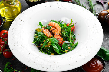 Salad with shrimp and arugula on a plate, restaurant serving. Top view. Free space for text.