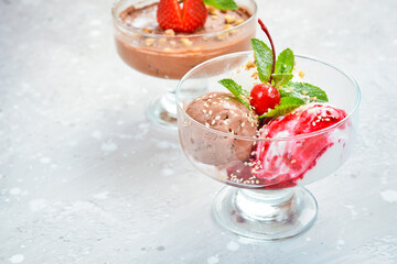 Sweet chocolate and strawberry ice cream in glasses. Top view. Free space for text.