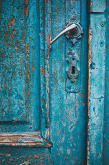 Weathered turquoise door with patina in Brasov, Romania