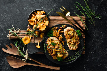 Bruschetta with chanterelle mushrooms and onions. On a stone plate. Free space for text.