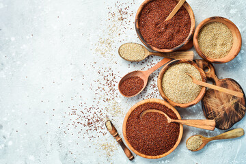 Quinoa set Red, white and brown quinoa. On a black background. Top view. Free copy space.