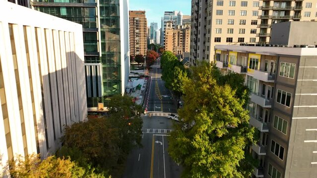 Downtown urban city setting. Aerial flight among highrise buildings in American city. Apartment and condo buildings in USA.
