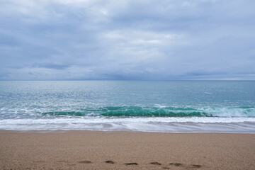Fototapeta na wymiar Turquoise sea waves hitting a sandy beach