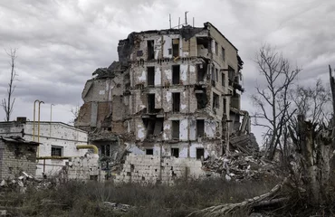Selbstklebende Fototapete Kiew destroyed and burned houses in the city Russia Ukraine war