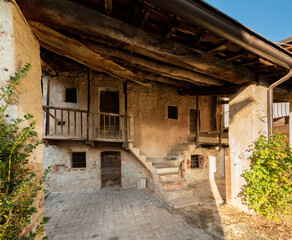 Fototapeta na wymiar Old rustic mountain house with wooden balconies in Boves village in Piedmont, Italy