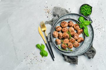 Homemade beef meatballs on a plate. Top view. On a stone background.