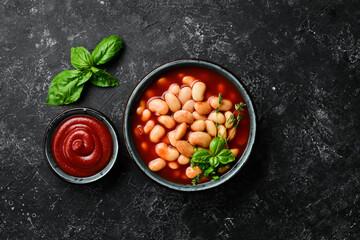 Traditional turkish food. Dried white beans with tomato paste in plate. Top view. On a stone background.