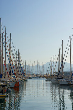 Pier with yachts. Many beautiful yachts with masts in the marina. Vacation, travel, luxury concept