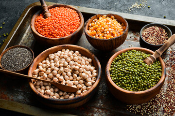 Various cereals and legumes: rice, peas, lentils, beans, mung beans, buckwheat, chia, corn and chickpeas. Top view. Banner in the title of the site