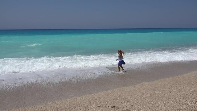 Kid Playing on Beach, Child Running on Seashore at Sunset, Little Girl Watching Sea Waves on Coastline Shore in Summer Vacation