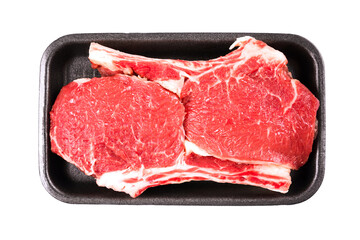 Raw ribeye beef steak ready for grilling in black food container isolated on white