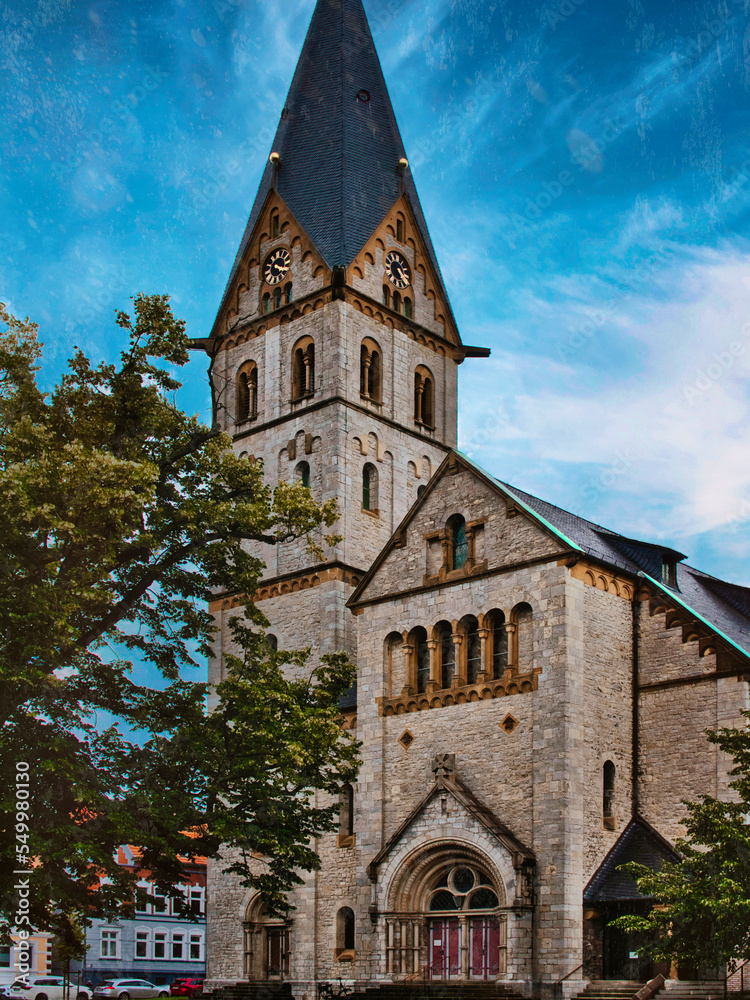 Wall mural old church towering in the city with old ornate windows