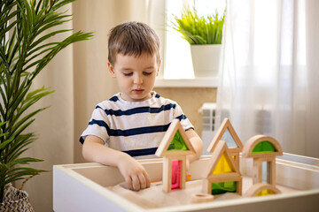 Cute baby boy playing sand table therapy toys developing game at home. Early development