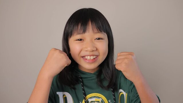 Little asian teenage girl shows her motivation.