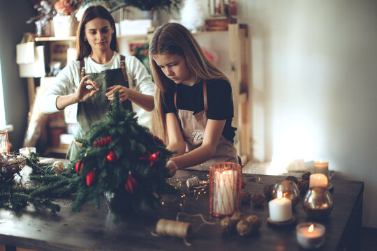 A woman makes a Christmas tree with her own hands. High quality photo