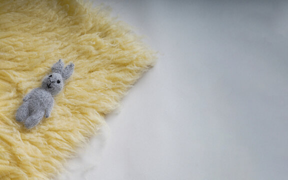 Grey teddy on a fabric background. New Born, communion or baptism Greeting Card. Copy space.