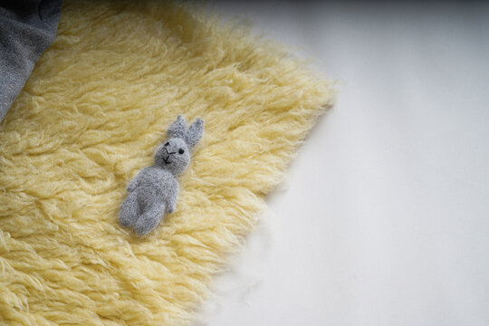 Grey teddy on a fabric background. New Born, communion or baptism Greeting Card. Copy space.